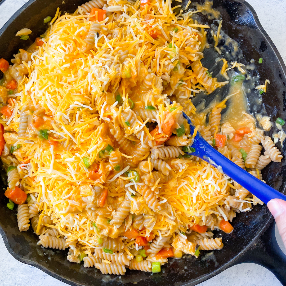 Buffalo chicken pasta bake in a skillet